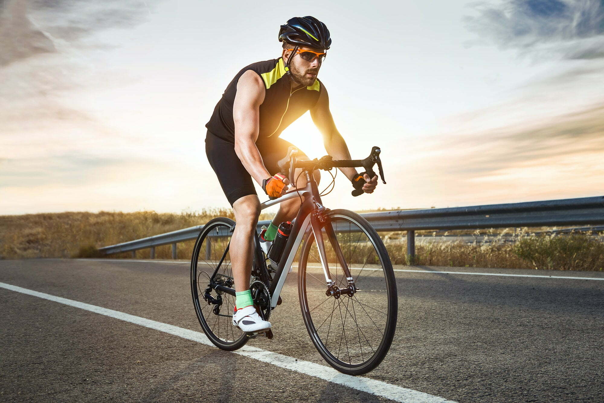 Handsome young man cycling on the road.